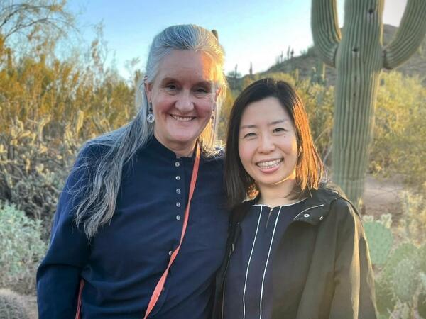 Monica and Megumi standing together in the garden